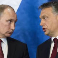 Russian President Vladimir Putin (left) listens to Hungarian Prime Minister Viktor Orban during a signing ceremony at the parliament building in Budapest on Tuesday. | AP