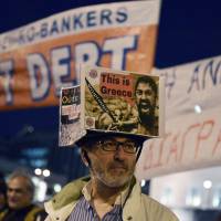 Greeks gather Monday in front of the parliament during a pro-government demonstration in Athens. | AFP-JIJI