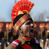 A new recruit of the Indian paramilitary Border Security Force calls recruits to attention during a passing-out parade on the outskirts of Srinagar on Jan. 30. India and China contest a number of pieces of territory. | AFP-JIJI