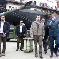 Lebanese Brig. Gen. Manuel Kirejian chats with U.S. Ambassador to Lebanon David Hale as they review weapons donated by the U.S. government to the Lebanese army during a ceremony at Beirut\'s port Sunday. More than 70 M198 Howitzers, as well as 26 million rounds of ammunition, including small, medium, and heavy artillery rounds, were delivered on Sunday from the United States as military aid to the Lebanese army. | REUTERS