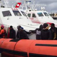 Migrants disembark Tuesday from a boat from the Italian coast guard after a rescue operation off the coast of Lampedusa Monday. Twenty-nine African migrants intercepted by Italian authorities while trying to reach Europe by boat in rough and icy conditions have died of hypothermia, most after being rescued, sources told AFP. Coast guard speedboats picked up 105 migrants in the Mediterranean overnight, seven of whom were already dead, from a converted fishing boat battered by high winds and waves that hit 8 meters. Aid agencies see many more migrant deaths in Mediterranean amid curtailed patrols