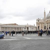 An Italian police car patrols in front of Saint Peter\'s Basilica in Rome on Monday. Pope Francis expressed deep sadness for the beheading of 21 Egyptian Coptic Christians in Libya, departing from the script of an address on Monday to emphasise the unity of all Christians regardless of the sect they follow. | REUTERS