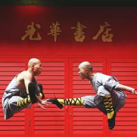 Shaolin monks fly through the air in this photograph taken in London’s Chinatown on Monday. The temple, which practices Shaolin kung-fu, believed to be the oldest institutionalized style of the martial art in the world, is planning to build a roughly $300 million complex in Australia that will include a temple, hotel, academy and a golf course. Shaolin Temple is located in Henan province in eastern China. China's famed Shaolin Temple plans big development project in Australia