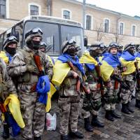 Ukrainian police officers stand during a ceremony in Kharkiv, northeastern Ukrainian, on Friday ahead of their departure to the east of the country, where they were to take part in an anti-terrorist operation. | AFP