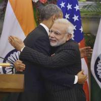U.S. President Barack Obama and Indian Prime Minister Narendra Modi hug after jointly addressing the media following talks in New Delhi on Jan. 25. | AP
