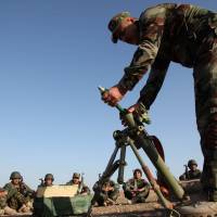 Volunteers from the Yazidi sect who have joined the Kurdish peshmerga take part in a training exercise on the outskirts of the town of Sinjar on Feb. 3. | REUTERS