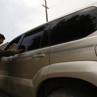 A Houthi militiaman inspects a car at a checkpoint in Sanaa on Tuesday. Gunmen kidnapped a Frenchwoman and her Yemeni driver in Yemen\'s capital in the morning as she was on her way to work, Yemeni security sources and French authorities said. | REUTERS