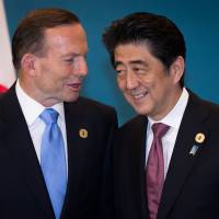 Australia Prime Minister Tony Abbott speaks with Prime Minister Shinzo Abe during a trilateral meeting at the Group of 20 summit in Brisbane, Australia, on Nov. 16, 2014. Abbott is currently facing a possible leadership challenge from within his own Liberal party.  | BLOOMBERG