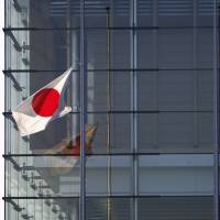 A Hinomaru flag flies at half-staff to mourn Japanese hostage victims captured by Islamic State militants at Prime Minister Shinzo Abe’s official residence in Tokyo on Monday. Abe said the same day he wanted to debate the possibility of Japan’s military rescuing Japanese citizens abroad, a day after Islamic State militants said they had beheaded Japanese journalist Kenji Goto. Abe defends handling of hostage crisis, declaration of aid to fight Islamic State