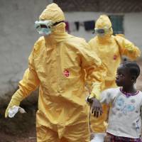A Liberian girl is taken to an ambulance after showing signs of the Ebola infection in the village of Freeman Reserve, about 30 miles north of Monrovia, in September 2014. An experimental anti-viral drug developed in Japan has shown encouraging signs of effectiveness in its first human tests against the deadly disease that ravaged West Africa last year.  | AP