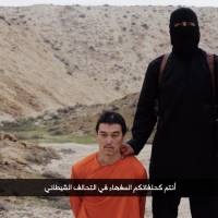A screenshot of a purportedly Islamic State video uploaded early Sunday morning shows captured Japanese journalist Kenji Goto. A still image included in the video appears to show Goto’s dead body. | AFP