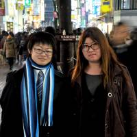 Kazuki Osawa (left), a transgender male who remains legally female, and his partner, Shoi Osawa, pose in Shinjuku Ward, Tokyo, on Jan. 30. | YOSHIAKI MIURA