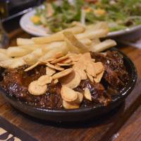 Beef festival: Wild steak topped with roasted garlic, served with fries | J.J. O\'DONOGHUE