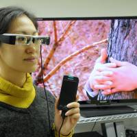 People who are deaf or blind can participate in a movie screening by wearing a special pair of UDCast glasses that are connected to an iPhone. Options allow Tokyo to be more accessible