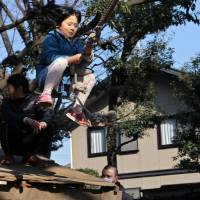 A girl launches herslf on the Tarzan Swing. | KIT NAGAMURA