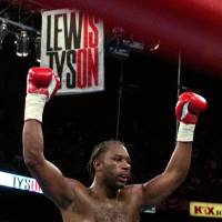 Saw opening: World heavyweight champion Lennox Lewis reacts after knocking out Mike Tyson in the eighth round of their title fight in Memphis, Tennessee, on June 8, 2002. | AP