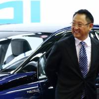 Akio Toyoda, president of Toyota Motor Corp., stands in front of the company\'s Mirai fuel-cell vehicle during the a ceremony at the Motomachi plant in Toyota, Aichi Prefecture, Japan, on Feb. 24. | BLOOMBERG