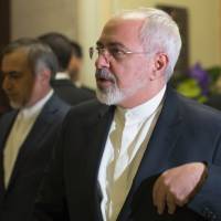 Iran\'s Foreign Minister Javad Zarif enters another negotiating meeting with U.S. Secretary of State John Kerry over Iran\'s nuclear program in Lausanne, Switzerland, on Wednesday.  | AFP-JIJI/POOL