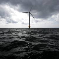 A wind turbine developed by New Energy and Industrial Technology Development Organization in a joint research project with Tokyo Electric Power Co. stands in the sea off Choshi, Chiba Prefecture, in March 2013. | BLOOMBERG