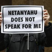 A demonstrator holds a sign during a rally near the Israeli Consulate in New York on Tuesday, after Israeli Prime Minister Benjamin Netanyahu warned U.S. President Barack Obama against accepting a nuclear deal with Iran. | REUTERS