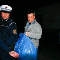 German police carry bags out of a house believed to belong to the parents of crashed Germanwings Flight 9524 co-pilot Andreas Lubitz in Montabaur on Thursday. The young German co-pilot locked himself in the cockpit of the Airbus and flew it into a mountain, killing all 150 people on board, prosecutors said on Thursday. | REUTERS
