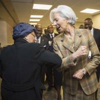 IMF Managing Director Christine Lagarde greets Liberian President Ellen Johnson Sirleaf with elbows as they \"greet people in Liberia\" to help fight Ebola\'s contagion at the IMF Headquarters after their meeting in Washington Friday. Tests are planned using the drug ZMapp in Liberia and the U.S. in the coming months to see how effective it is against Ebola. | REUTERS