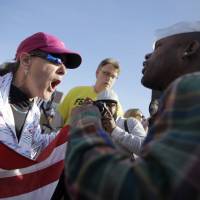 A pro-police protester (left) and civil rights demonstrator yell at each other outside the Ferguson Police Department on Sunday in the strife-hit Missouri city. | AP