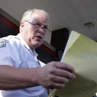 Ferguson, Missouri, Police Chief Thomas Jackson on Aug. 15 releases the name of the the officer accused of fatally shooting Michael Brown. Jackson reportedly plans to resign Wednesday in connection with a government report that criticizes his department for years of racial profiling. | AP