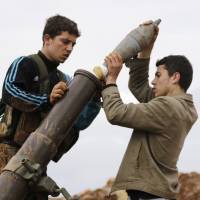 Members of the al-Qaida-linked Nusra Front prepare to fire a mortar toward forces loyal to Syrian President Bashar Assad north of Aleppo on Feb. 18. | REUTERS