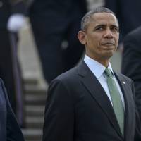 U.S. President Barack Obama walks with Republican Speaker of the House John Boehner ahead of a luncheon in Washington on March 17. According to a recent survey, a third of U.S. Republicans say Obama poses a more imminent threat to the country than Russian President Vladimir Putin and Syrian strongman Bashar Assad. | AFP-JIJI