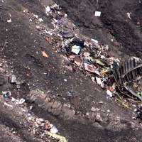 A screen grab taken from an AFP TV video on Tuesday shows debris of the Germanwings Airbus A320 at the crash site in the French Alps above the southeastern town of Seyne. The plane, which had taken off from Barcelona in Spain and was headed for Dusseldorf in Germany, crashed earlier in the day with 150 people onboard. French air traffic controllers helplessly watched the plane drop for eight minutes on radar, reportedly clearing other aircraft below it from its fatal path. Crash experts face mystery of eight-minute drop without a mayday; black box found