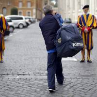 Roberto, a homeless man who lives around the Vatican, walks toward Swiss guards Thursday before entering the Vatican. Pope Francis made a surprise personal visit to 150 homeless people on a special tour of the Sistine Chapel on Thursday, in the latest nod to his vision of creating a church for the poor. | REUTERS