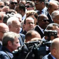 French President Francois Hollande (center) and President of Gabon Ali Bongo Ondimba (center right) take part in and anti-extremism march Sunday in Tunis. Tens of thousands of Tunisians attended the march in Tunis to denounce extremist violence following the attack on the National Bardo Museum. Tunisian forces kill nine militants, including suspected museum attack plotter, before world leaders attend 'Bardo' march