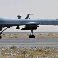 A U.S. Predator unmanned drone armed with a missile  sits on the tarmac of Kandahar military airport in Afghanistan in 2010. The U.S. military lost communication with an MG-1 Predator drone over Syria on Tuesday and is looking into claims by state media in Damascus that the robotic aircraft was shot down, officials said. | AFP-JIJI