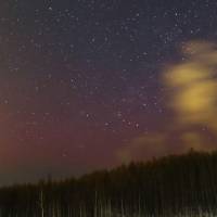 The sky glows red over mountains in Hokkaido early Wednesday because of the aurora borealis, as captured in this photo taken and provided by Katsuhito Nakajima of the Nayori Municipal Observatory. | KYODO