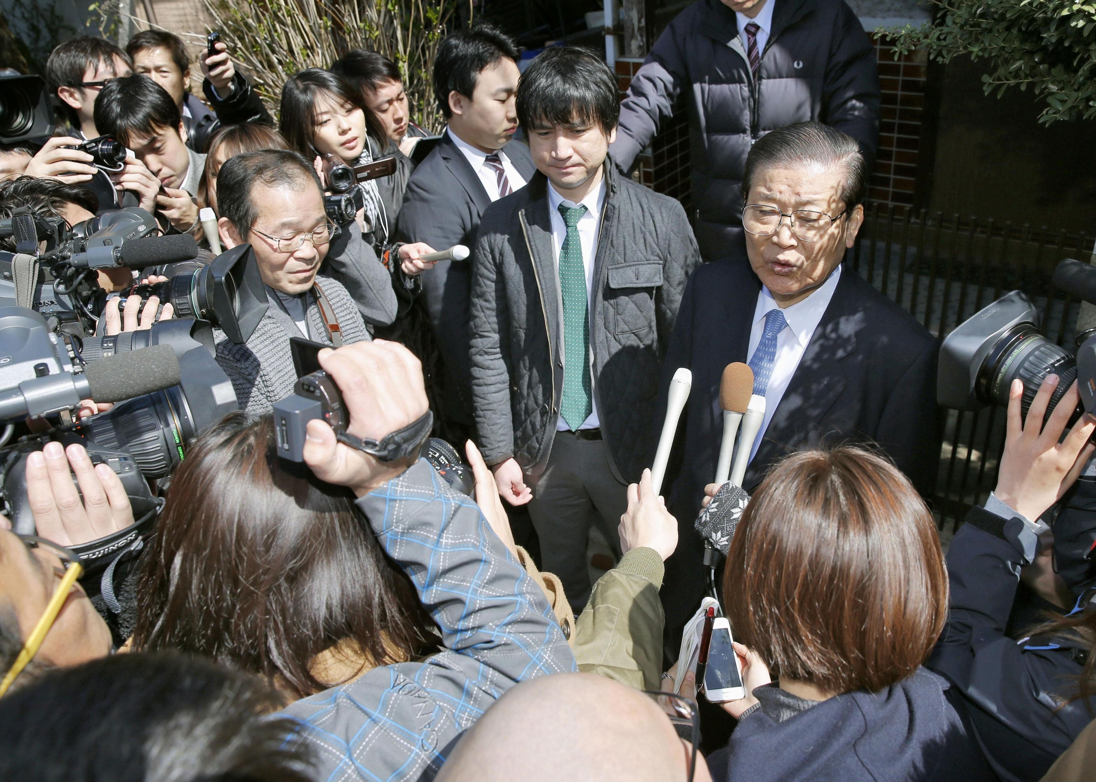 Ho Jong Man, chairman of the pro-Pyongyang General Association of Korean Residents in Japan, speaks to reporters outside his house in Tokyo's Suginami Ward after police raided it. | KYODO