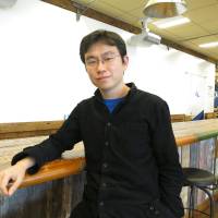 Kenzo Yoshida, who oversees DMM.make AKIBA, sits in the facility\'s shared office space on March 4. | KAZUAKI NAGATA