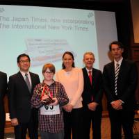Sean Fogerty (center), the 13-year-old winner of the 6th Japan Times Bee, poses with (from left) spelling judge Steve McClure, master of ceremonies Marc Davies, The Japan Times President Takeharu Tsutsumi, spelling judge Teru Clavel, pronouncer James Tschudy and The Japan Times Managing Editor Edan Corkill. | SATOKO KAWASAKI
