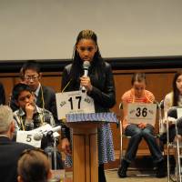 Kanijah Artis, 12, from Jack N. Darby Elementary School in Sasebo, Nagasaki Prefecture, spells a word during the 6th Japan Times Bee in Tokyo on Saturday. | SATOKO KAWASAKI