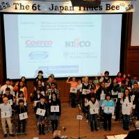 Sean Fogerty (center), the 13-year-old winner of the 6th Japan Times Bee, poses with (from left) spelling judge Steve McClure, master of ceremonies Marc Davies, The Japan Times President Takeharu Tsutsumi, spelling judge Teru Clavell, pronouncer James Tschudy and The Japan Times Managing Editor Edan Corkill. | SATOKO KAWASAKI