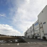 A vacant lot and commercial building owned by auto-parts maker Murata Spring Co. stands in an industrial park on the old site of a Panasonic Corp. factory in Utsunomiya, Tochigi Prefecture, on Feb. 13. | BLOOMBERG
