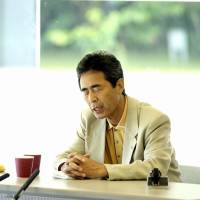 Akira Haraguchi recites pi digits at a public memorization event in Kisarazau, Chiba Prefecture, in 2006. At the event, covered by major media outlets, he managed to recite up to 100,000 digits of pi. | AKIRA HARAGUCHI
