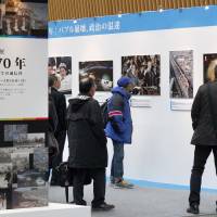 Visitors take in the exhibit \"70 Years After World War II &#8212; A News Agency as an Eyewitness\" last Friday at the Tokyo International Forum in Yurakucho. | KYODO