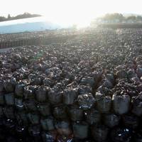 Bags of radioactive waste are seen piled up at a temporary storage site in Tomioka, Fukushima Prefecture, on Wednesday. Four years after the nuclear disaster began, a final disposal site for tainted debris it created has yet to be designated. | KYODO