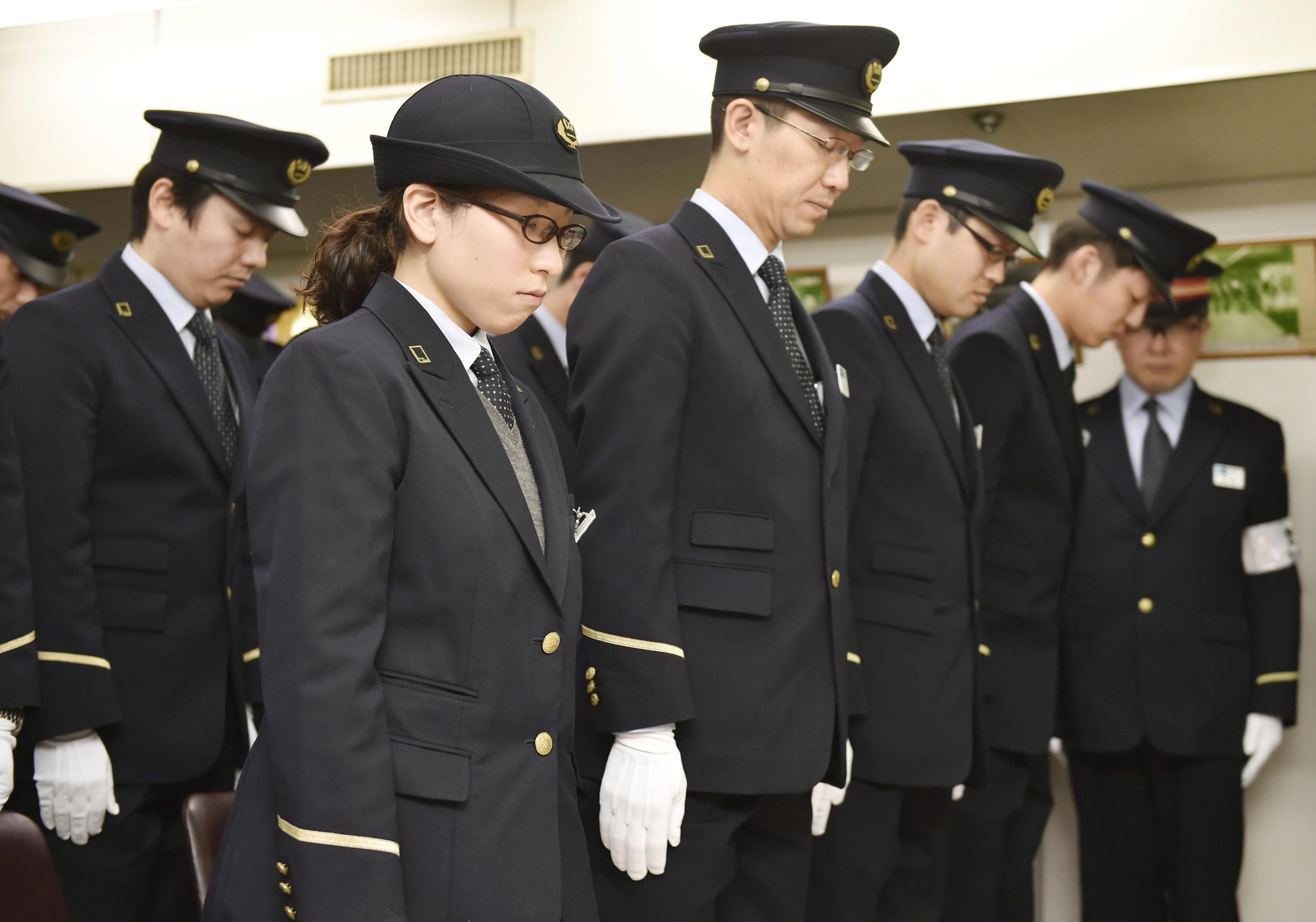 Tokyo Metro Co. staff observe a moment of silence Friday at Kasumigaseki Station to mark the 20th anniversary of the deadly sarin attack on the Tokyo subway system by doomsday cult Aum Shinrikyo. | KYODO