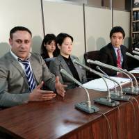 Syrian Joude Youssef (left) pleads for refugee status in Tokyo on Tuesday. He is one of four asylum seekers who arrived in 2012 and are now suing the government over their rejected applications. | TOMOHIRO OSAKI
