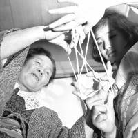 Bridging the generation gap: A girl plays ayatori, or cat’s cradle, with her mother in Tokyo in 1965. Reflections on war and childhood on a Tokyo train