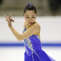 On the rise: Wakaba Higuchi performs her free skate program at the World Junior Figure Skating Championships on Friday. | KYODO