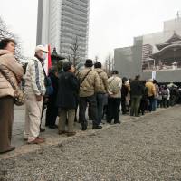 Mostly elderly attendees line up outside the Tokyo Metropolitan Memorial Hall in Yokoamicho Park on Tuesday for a service to mark the 70th anniversary of the Great Tokyo Air Raid. | IAN MUNROE