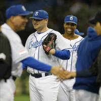 Joy of victory: Team Europe\'s Tom Stuifbergen (center) and his teammates celebrate their 6-2 win over Samurai Japan on Wednesday. | AP
